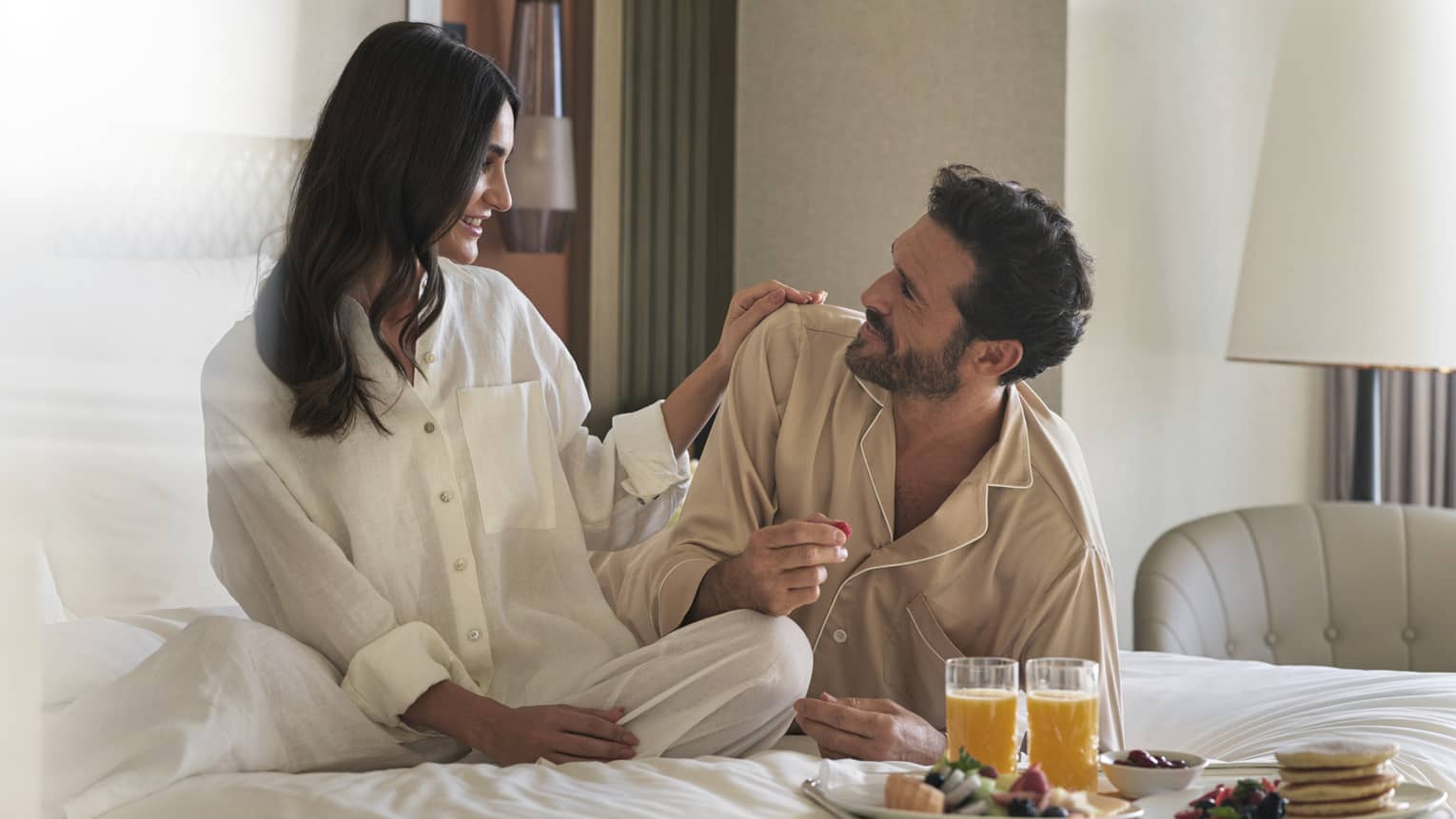 Pajama-clad couple enjoys in-room dining in their guest room