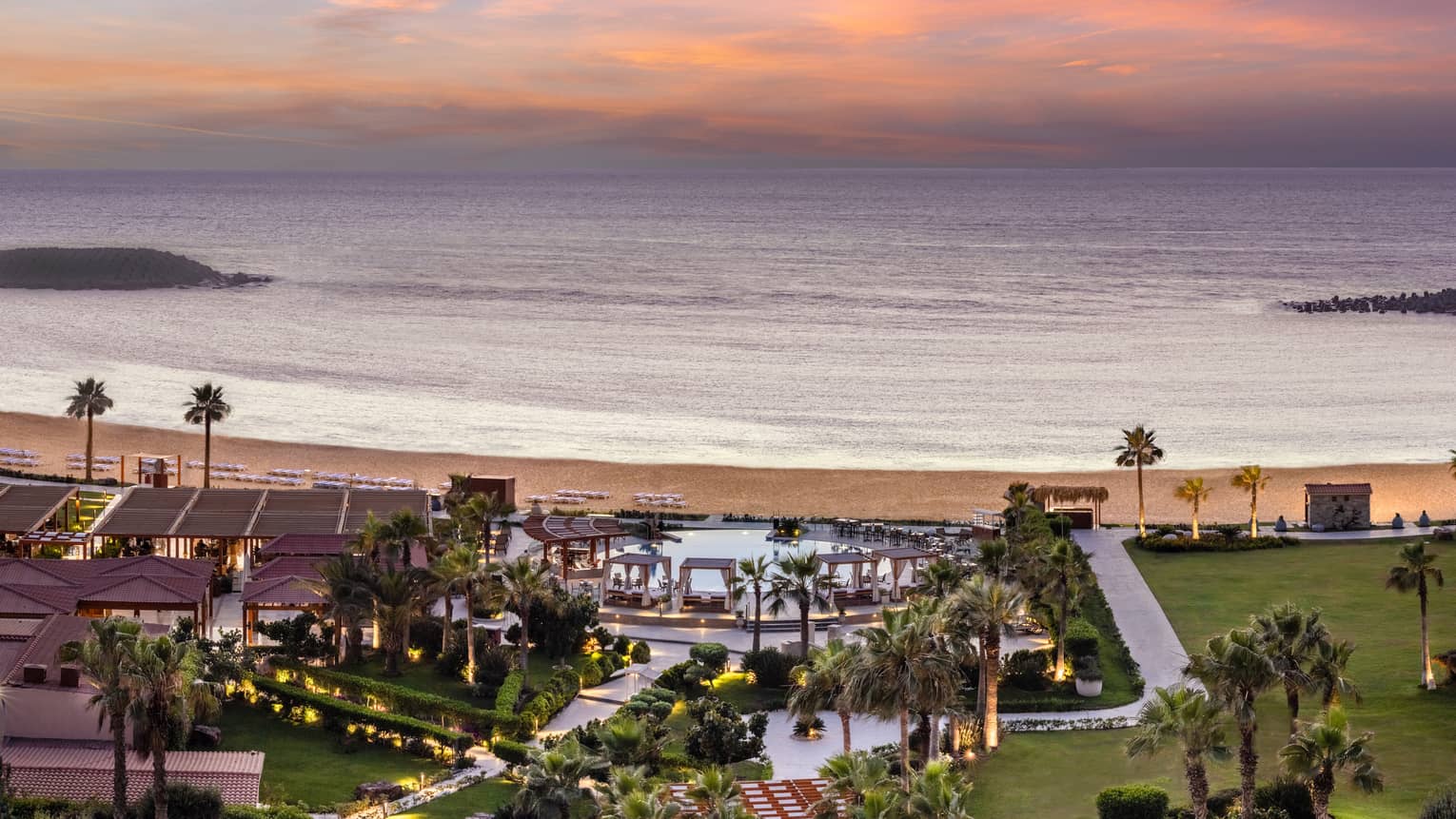 Aerial shot of pool and grounds leading to the beach from the Hotel