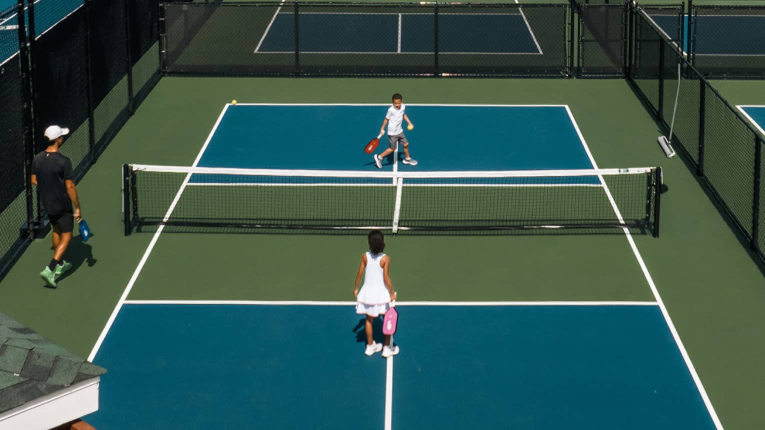 A tennis court with players on it.