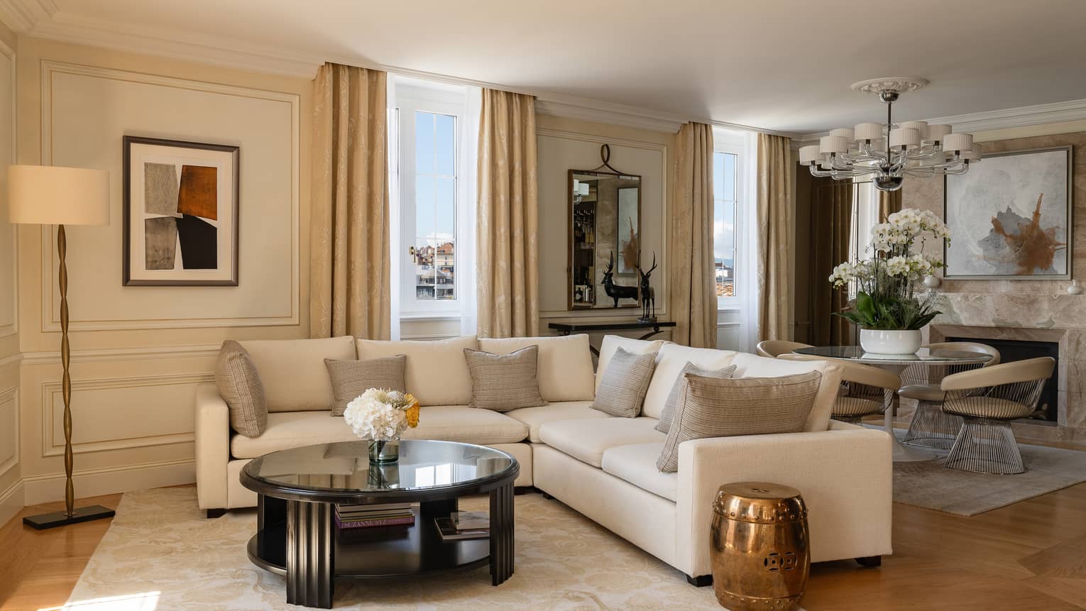 Presidential Suite Bergues at Four Seasons Hotel des Bergues, Geneva, featuring a sectional sofa and round dining table with large floral arrangement