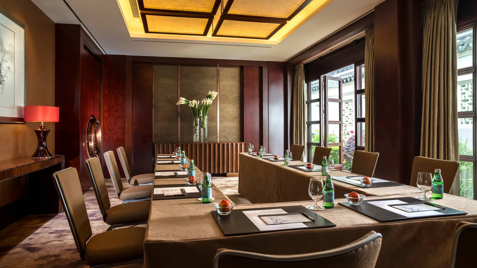 Horseshoe-shaped table lined with chairs in Pine Meeting Room