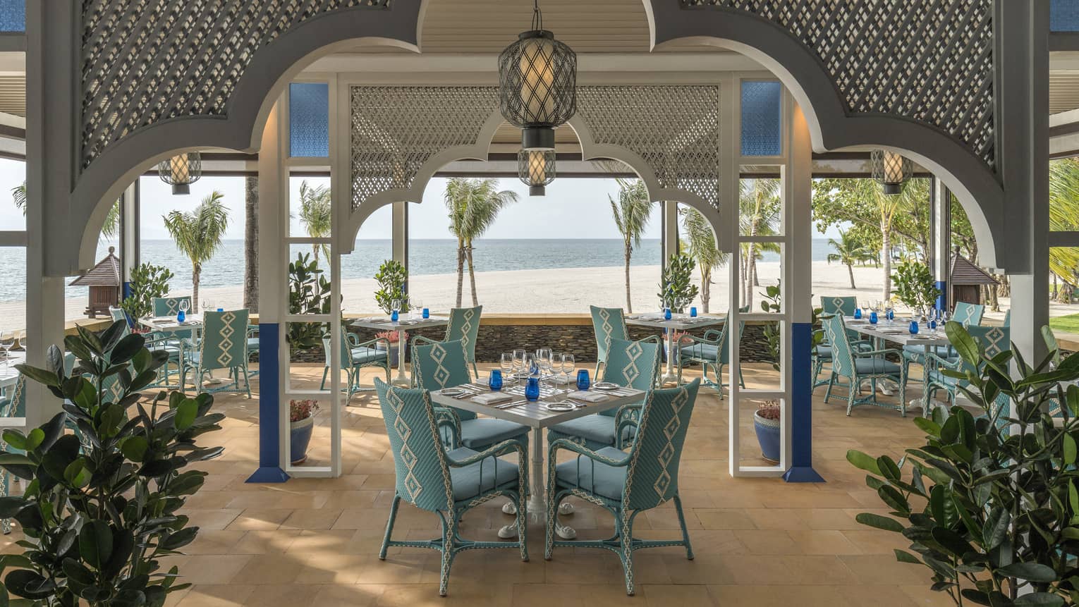 Upper Serai Restaurant dining area overlooking the beach with palm trees