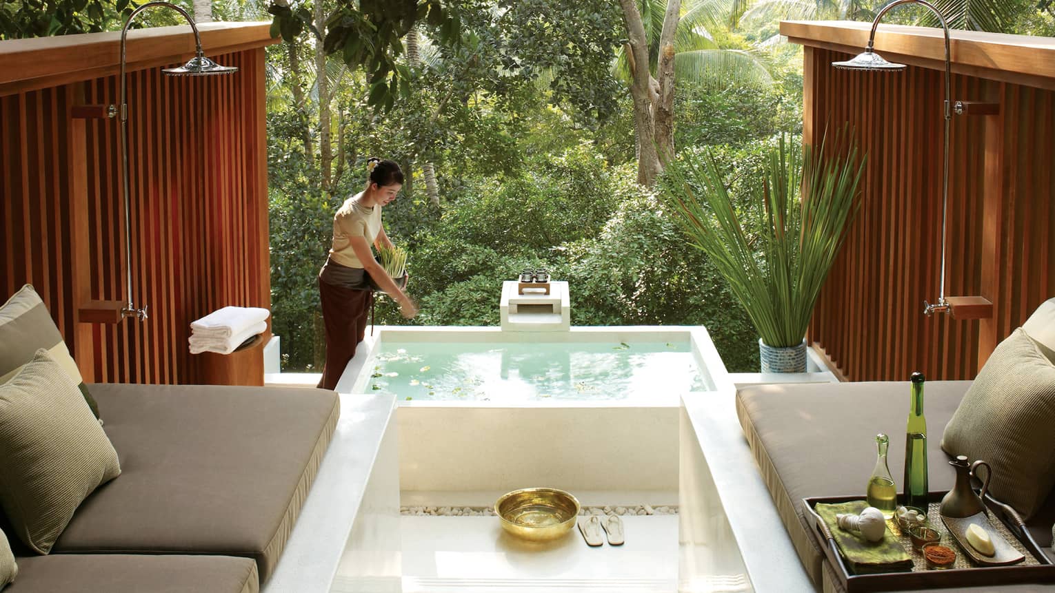 Plush cushioned benches around spa tub on outdoor patio