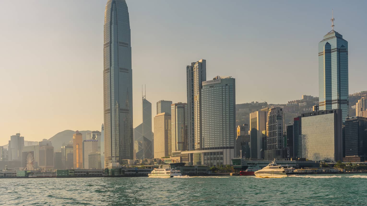High rise buildings along Hong Kong Harbour skyline at sunset