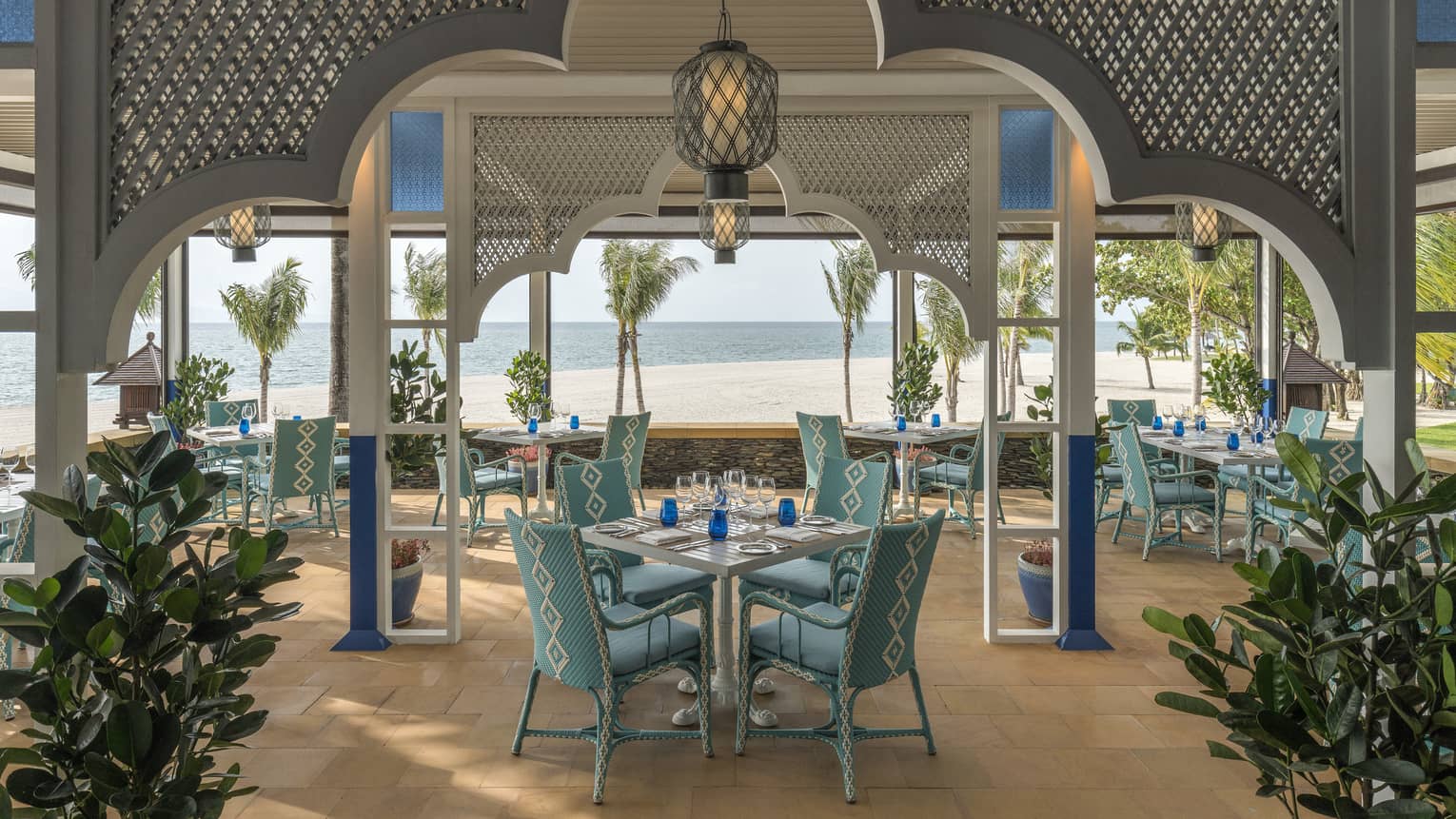 Upper Serai Restaurant dining area overlooking the beach with palm trees