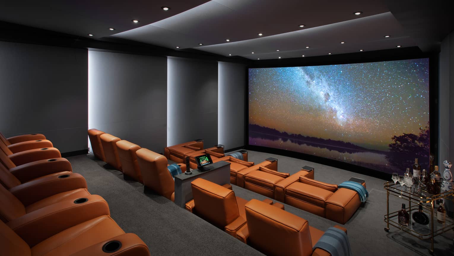 Imax screen and private cinema with theatre seating and bar cart