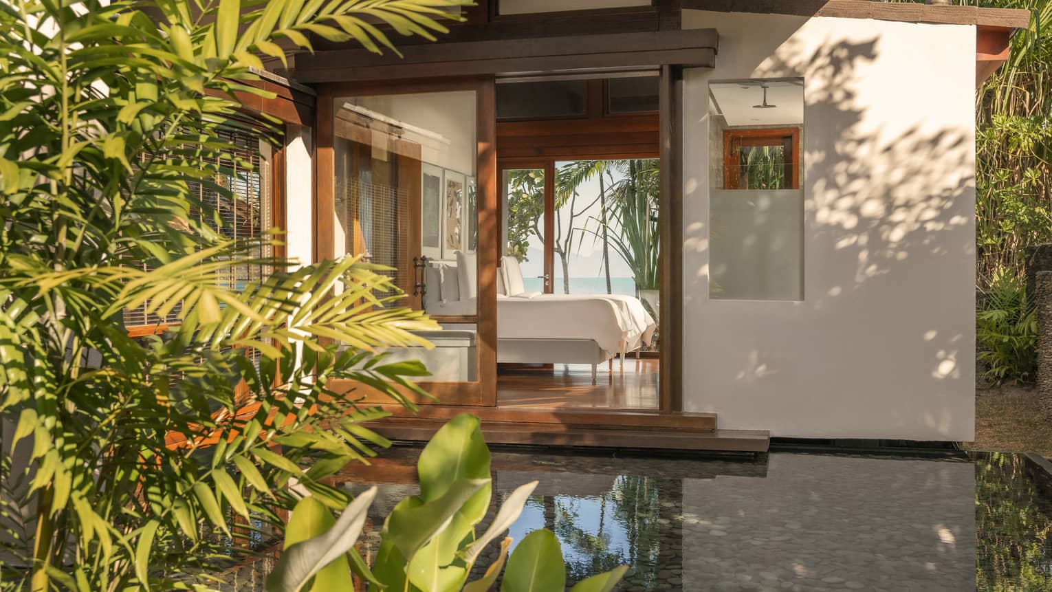 View of a Langkawi resort bedroom from the private garden terrace