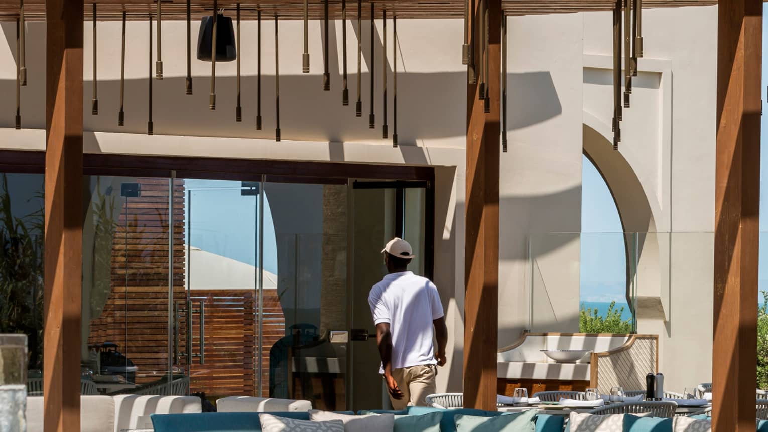 Staff serving and setting tables at poolside restaurant, Blu