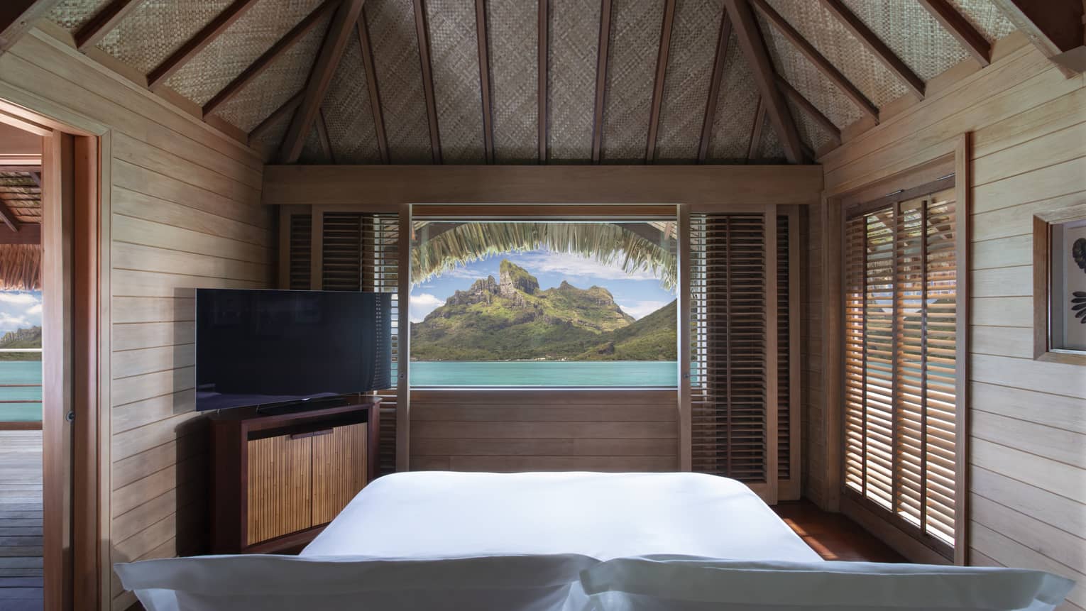 Lagoon and mountain view from a teak-walled guest room