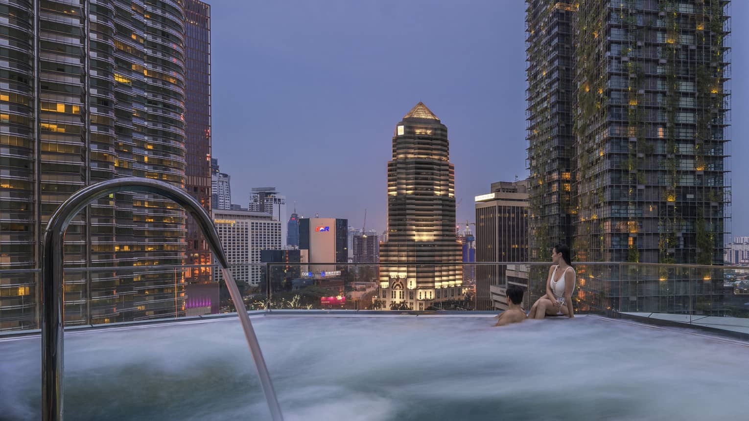 Pool with a view of the city skyline at Four Seasons Hotel Kuala Lumpur