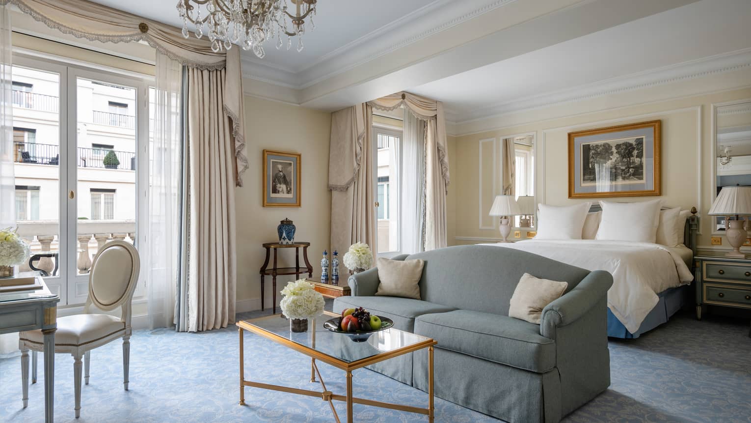 Premier room with queen bed, couch, coffee table, cream & teal Victorian accents, natural light 