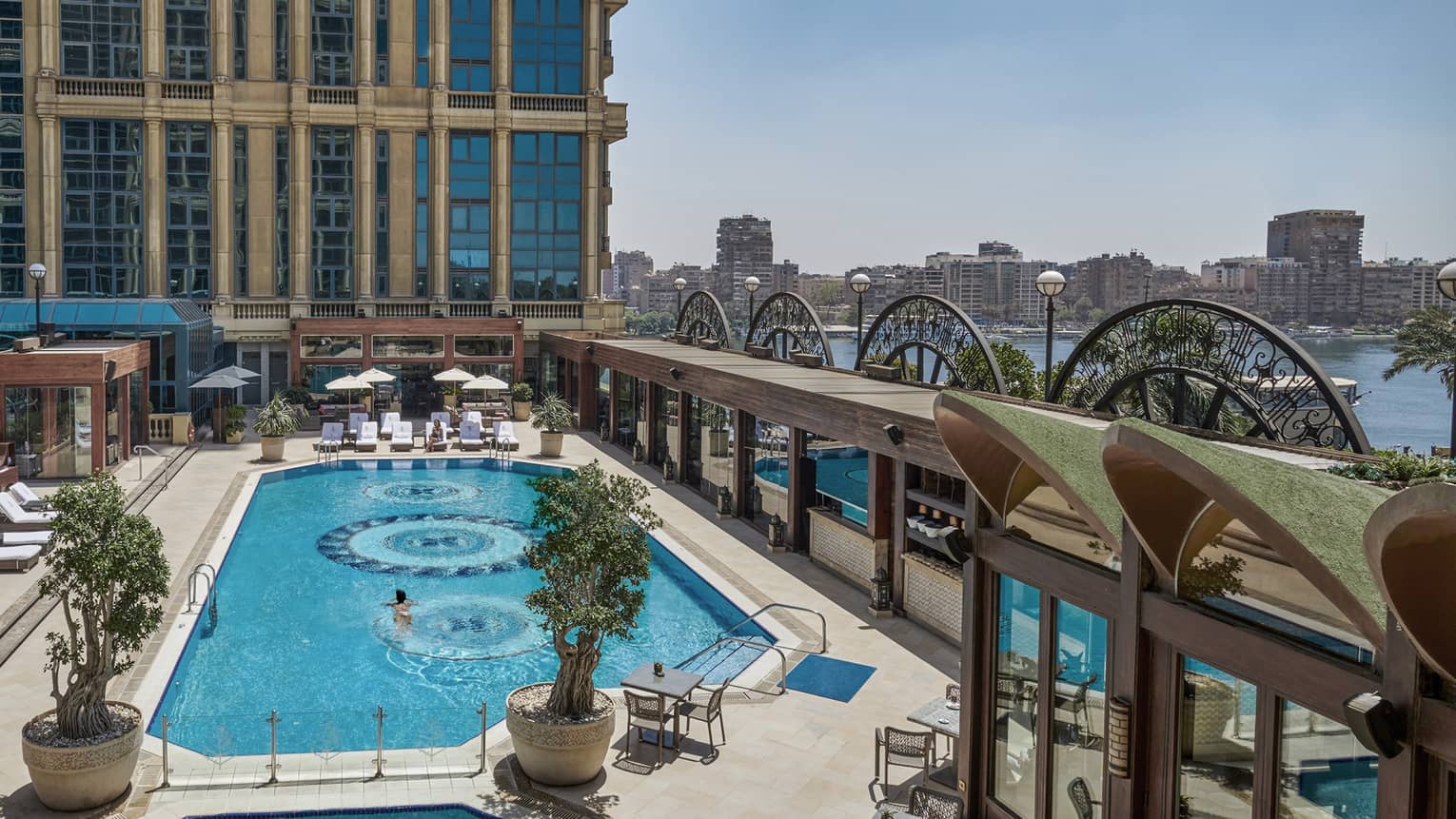 An art deco-inspired courtyard pool boasting stunning ocean and city views