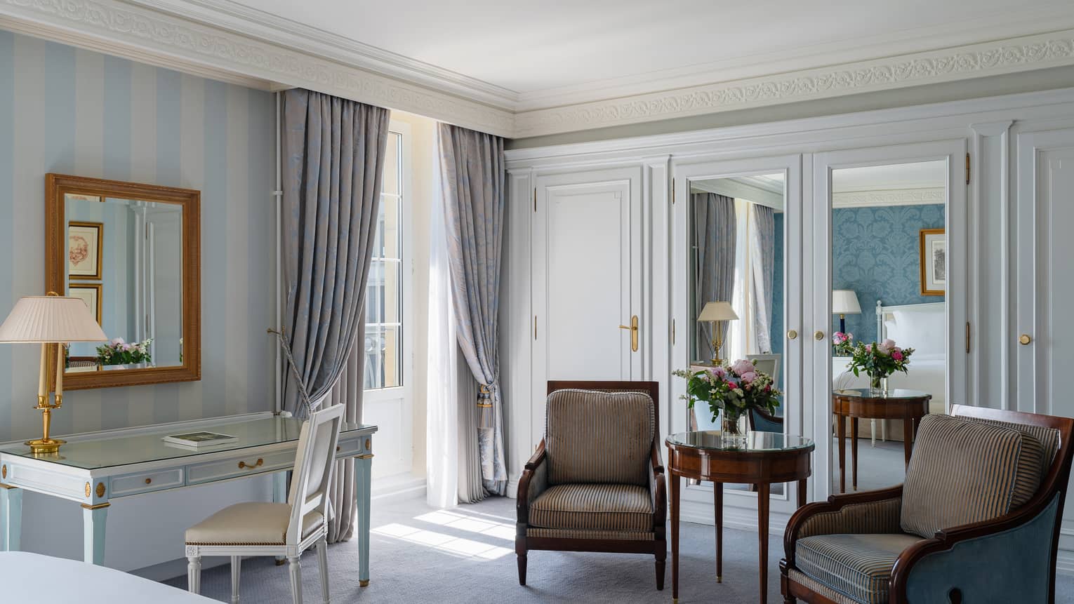 Luxury hotel room with desk and two arm chairs, at Four Seasons Hotel des Bergues, Geneva