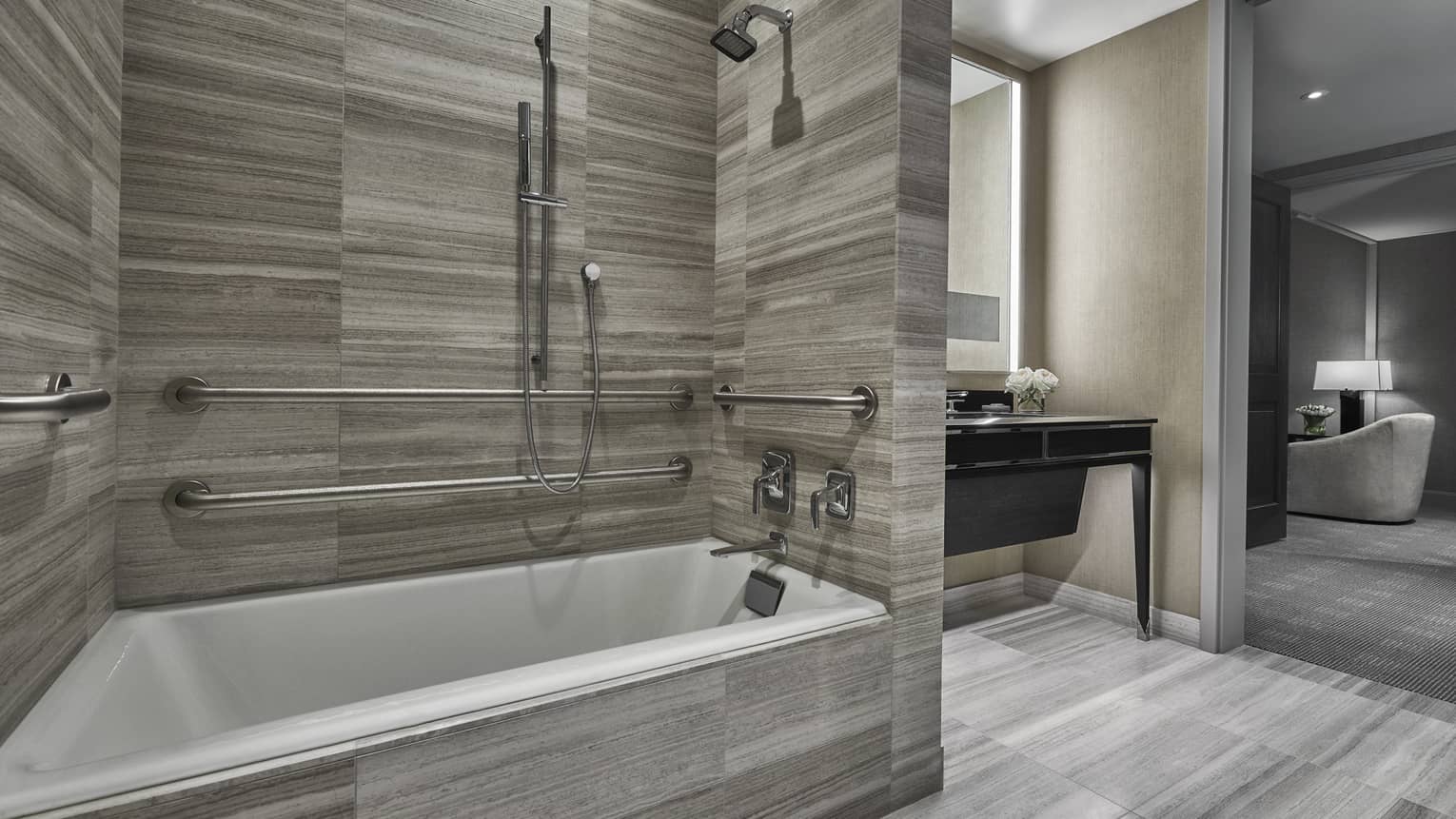 A neutral bathroom is adjacent to a bedroom at four seasons hotel boston one dalton