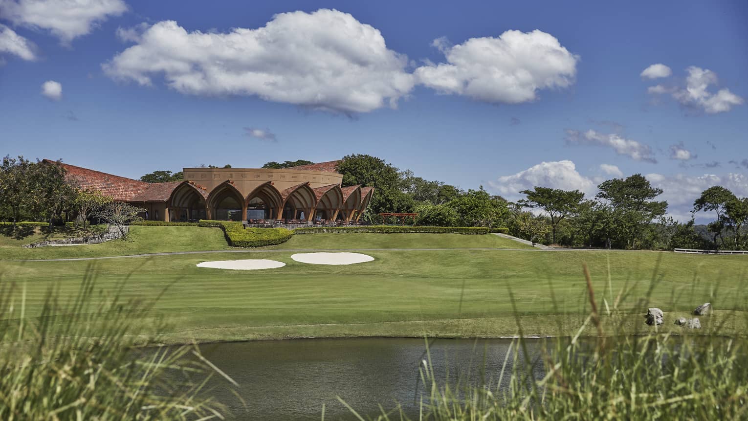 Sprawling golf course in Costa Rica with lake and tall grasses