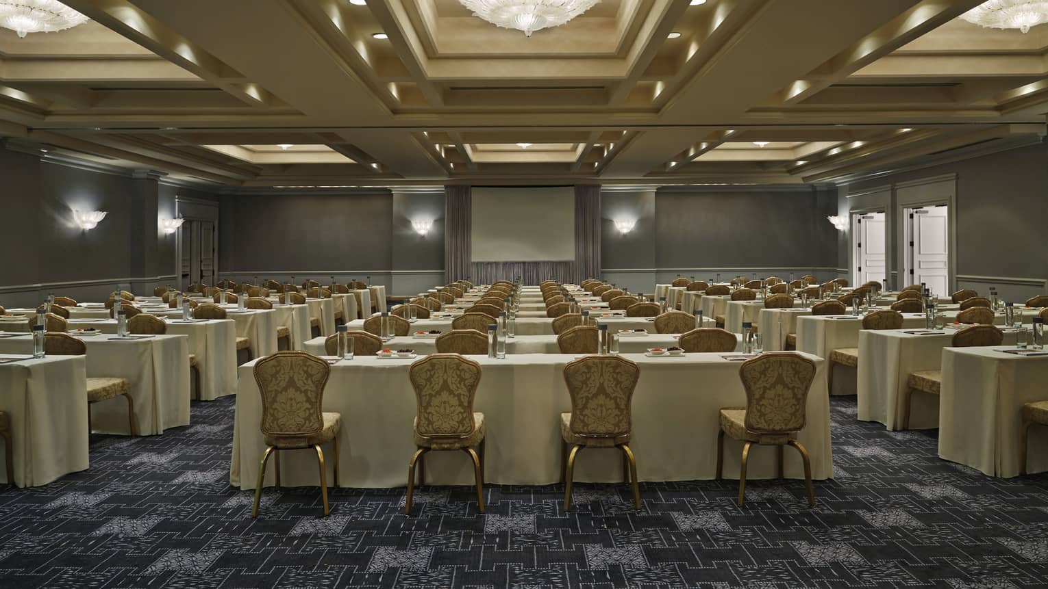 Flagler Ballroom conference with rows of meeting tables and chairs facing screen