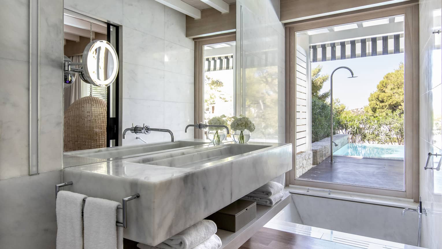 Bathroom with marble sink, lighted make-up mirror, walk-out terrace