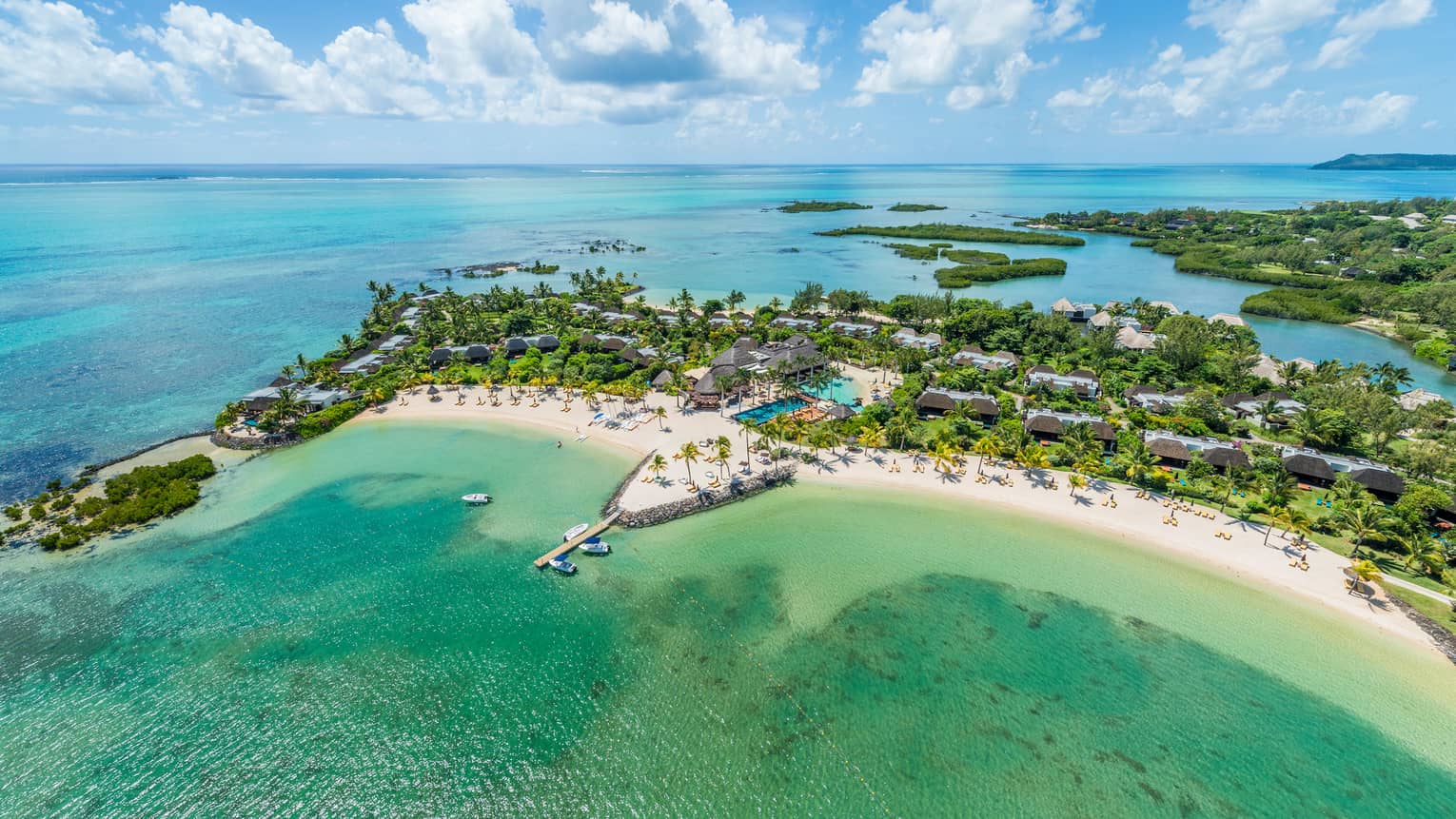 Aerial view of turquoise waters, white sand beach around Four Seasons Resort Mauritius