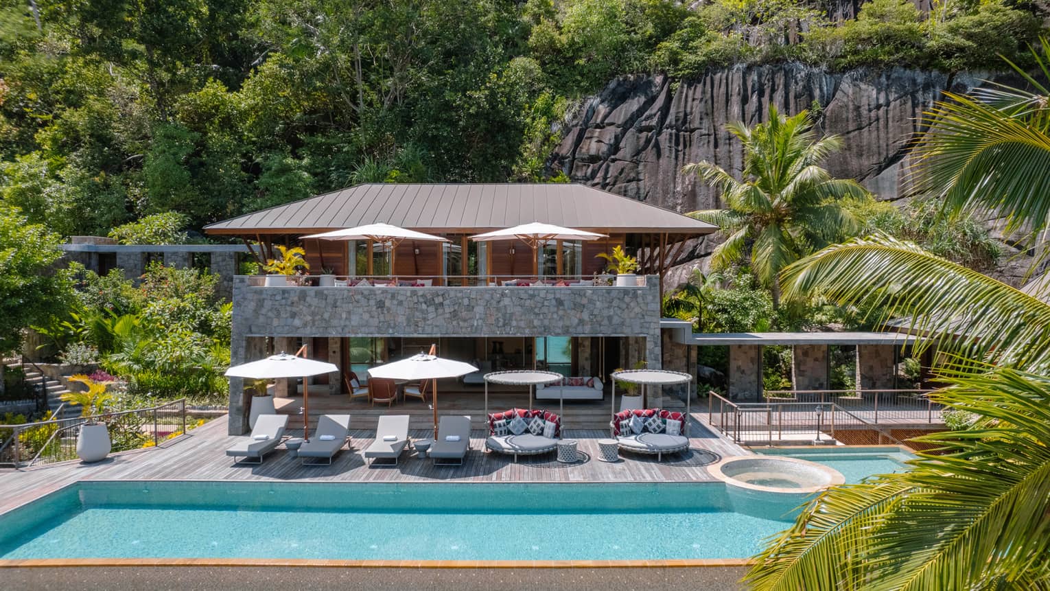 Exterior of three-bedroom beach suite in Seychelles, with large private pool and pool deck