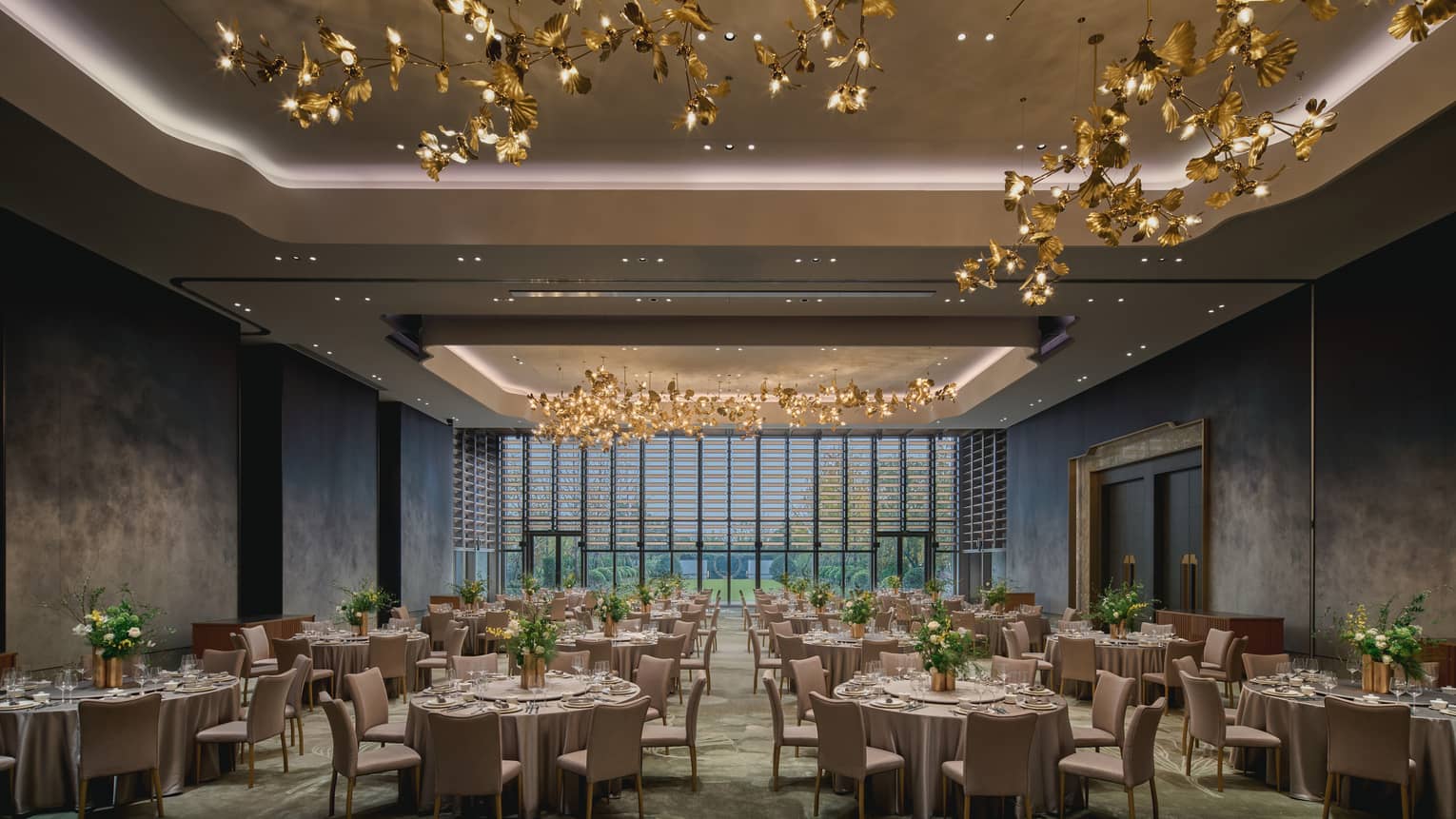Elegant ballroom with gold leaf lighting installation and banquet seating