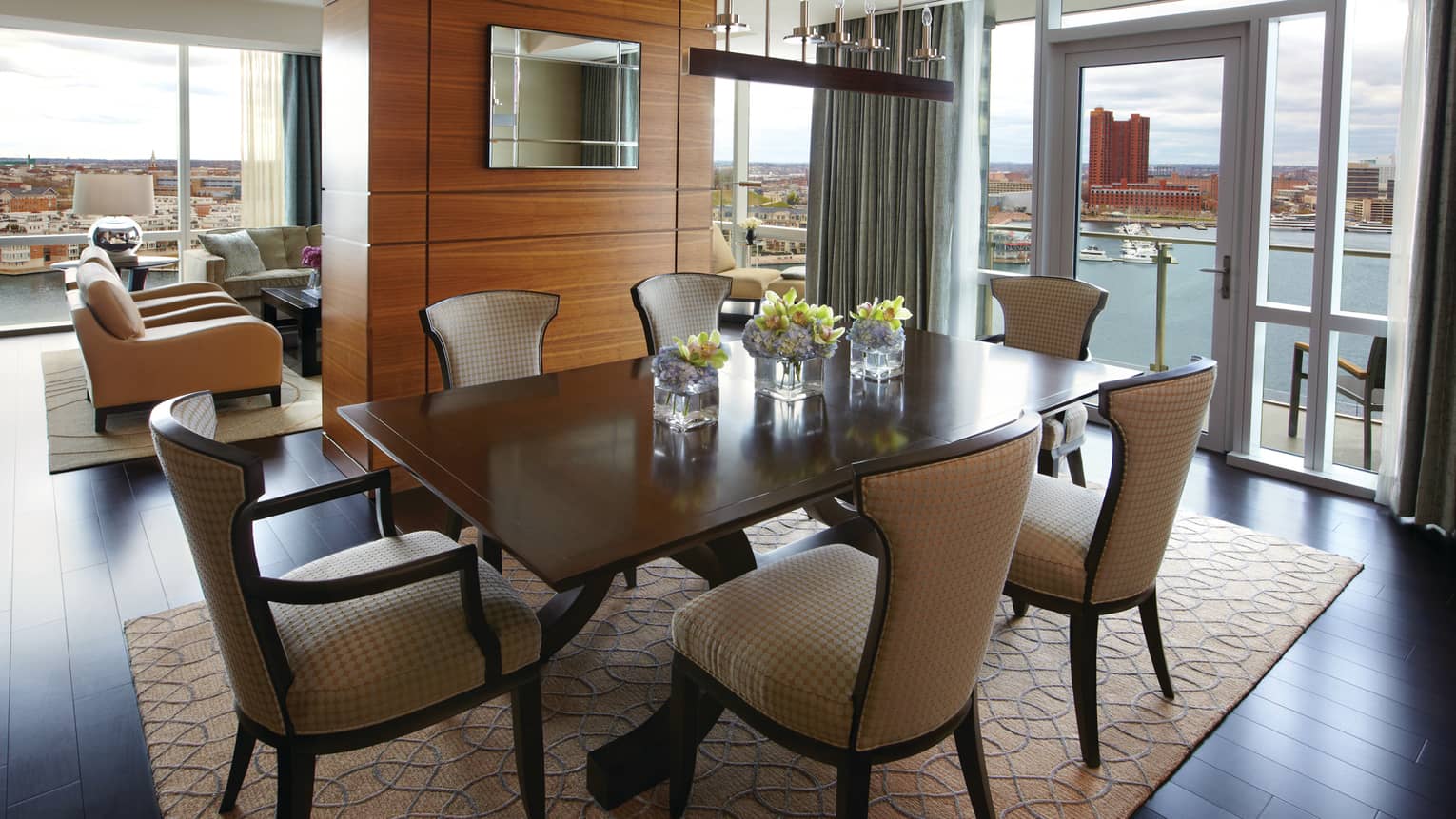Serene Suite dining table for six, adjoining living room, glass walls with harbour view