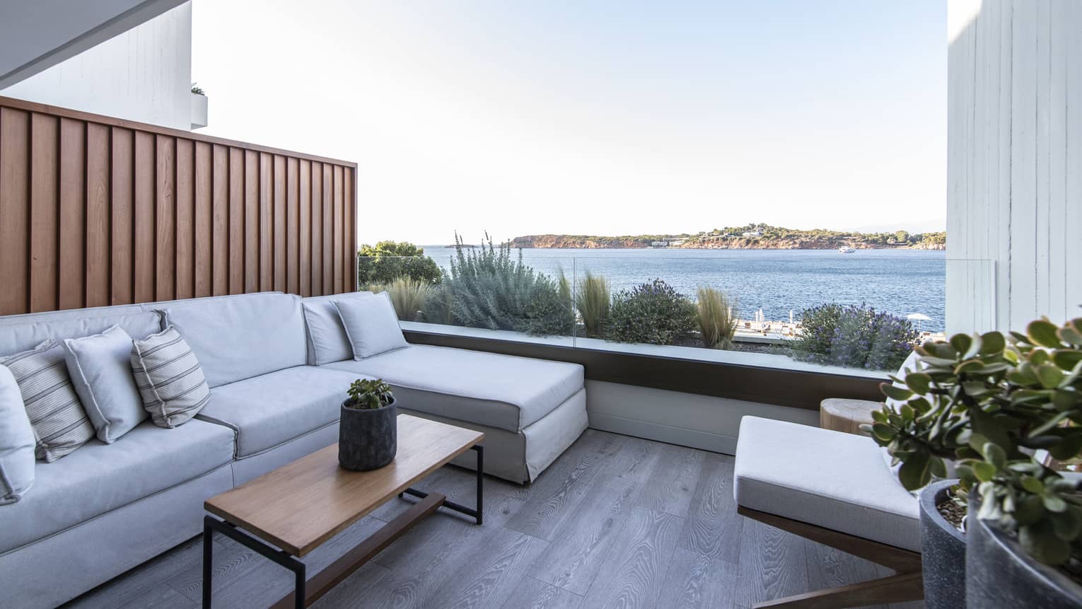 Small terrace with sectional sofa, coffee table sea view