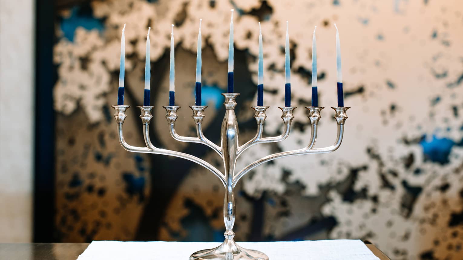 A silver menorah with 9 candles.