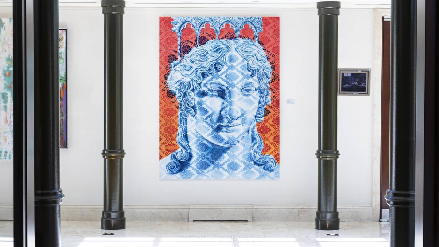 Modern lobby with black pillars and blue, red and white portrait painting
