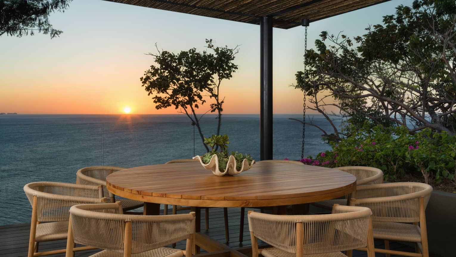 Round outdoor dining table with 6 chairs, sea view