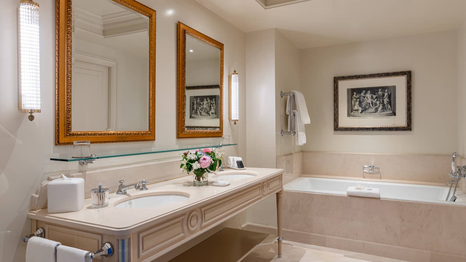 Hotel bathroom with two sinks, two framed mirrors and tub, at Four Seasons Hotel des Bergues, Geneva