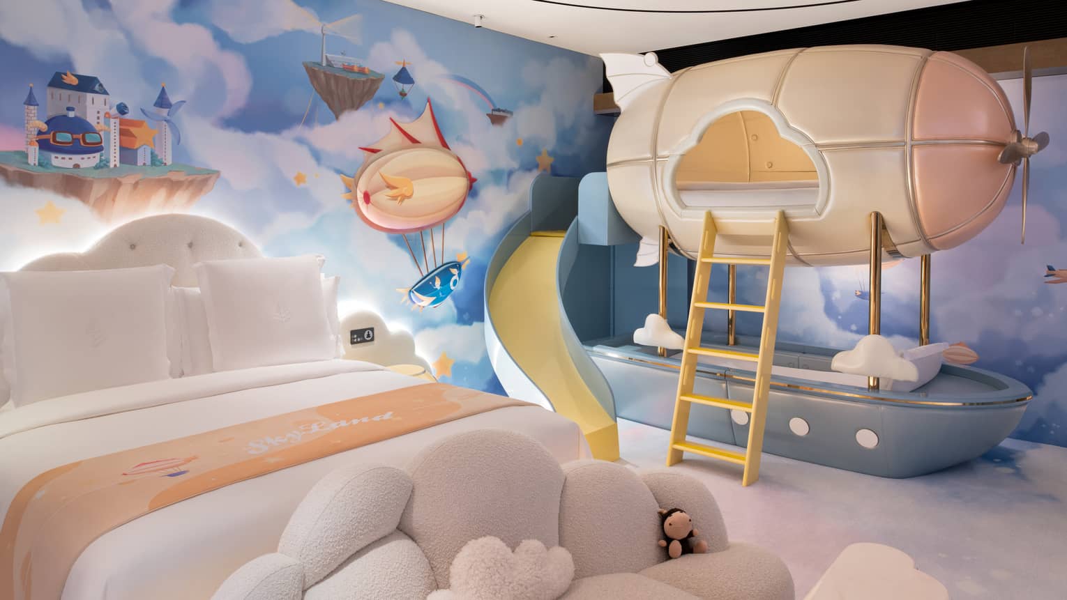 Family room with sky-inspired theme, adult bed and blimp-shaped bunk bed