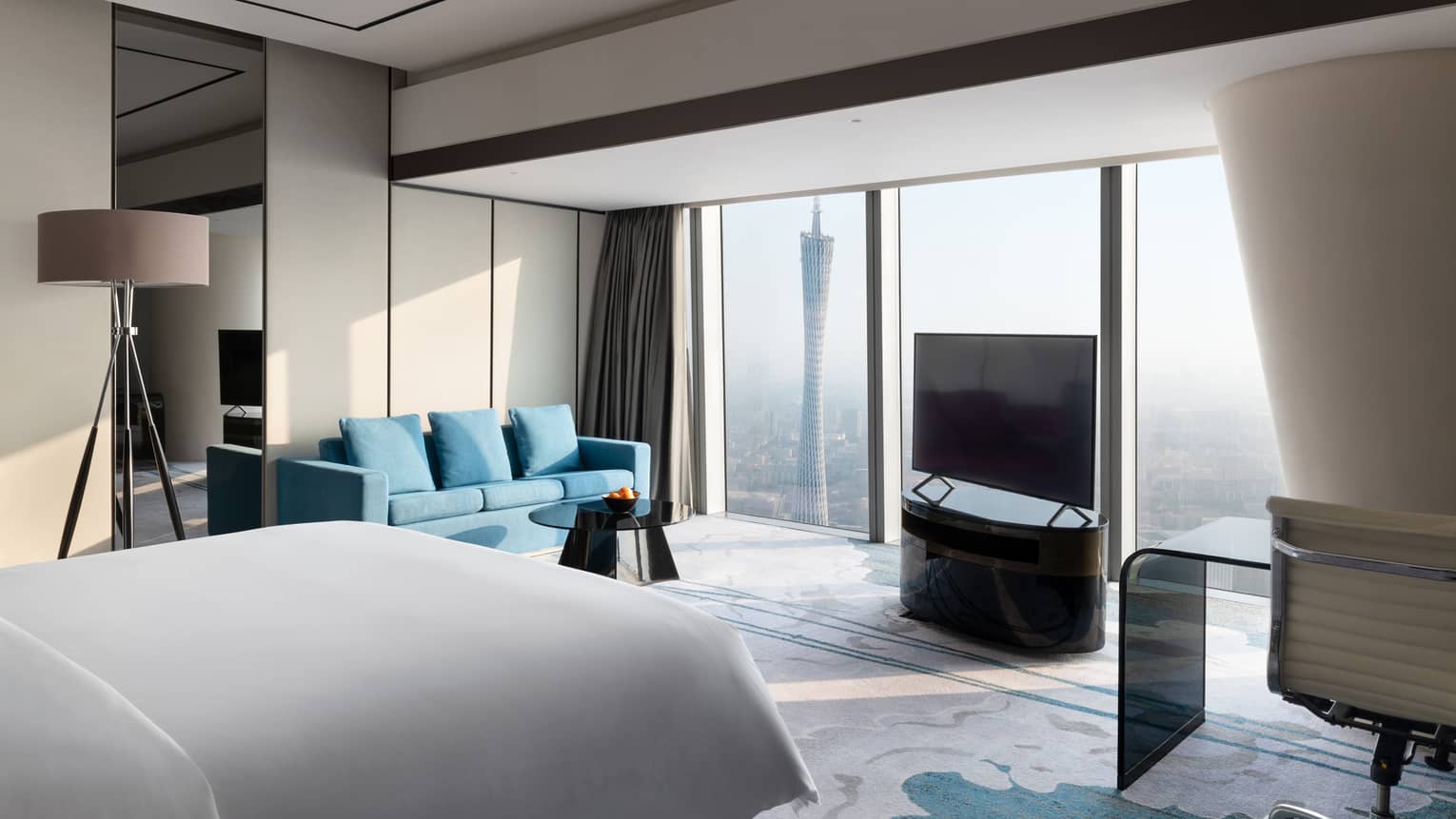 Premier King Canton Tower View Room with blue accents and floor-to-ceiling windows