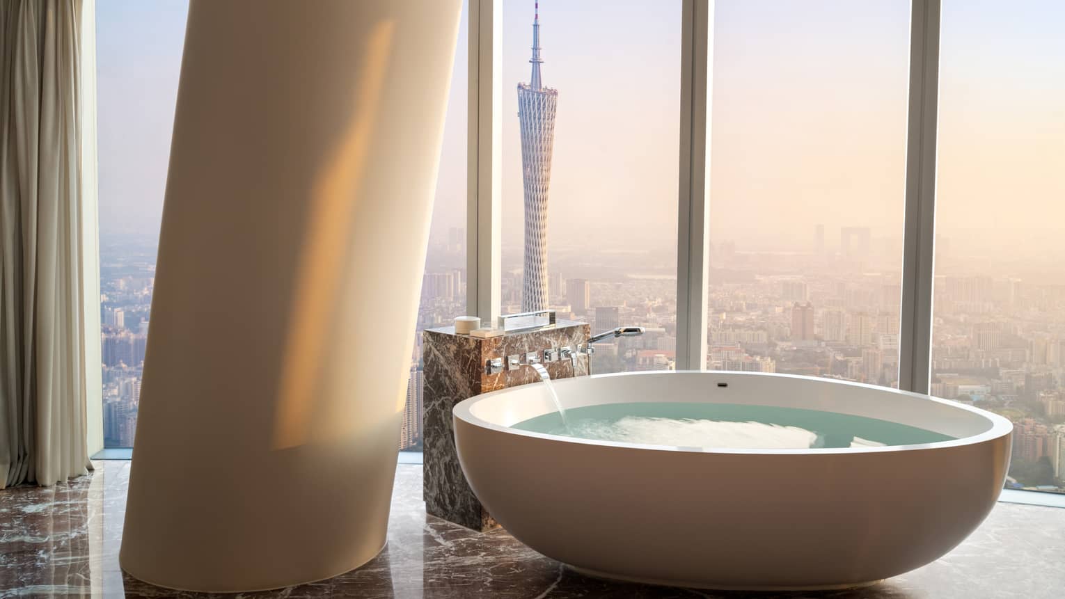 Deluxe Twin Canton Tower View Suite soaking tub with floor-to-ceiling windows