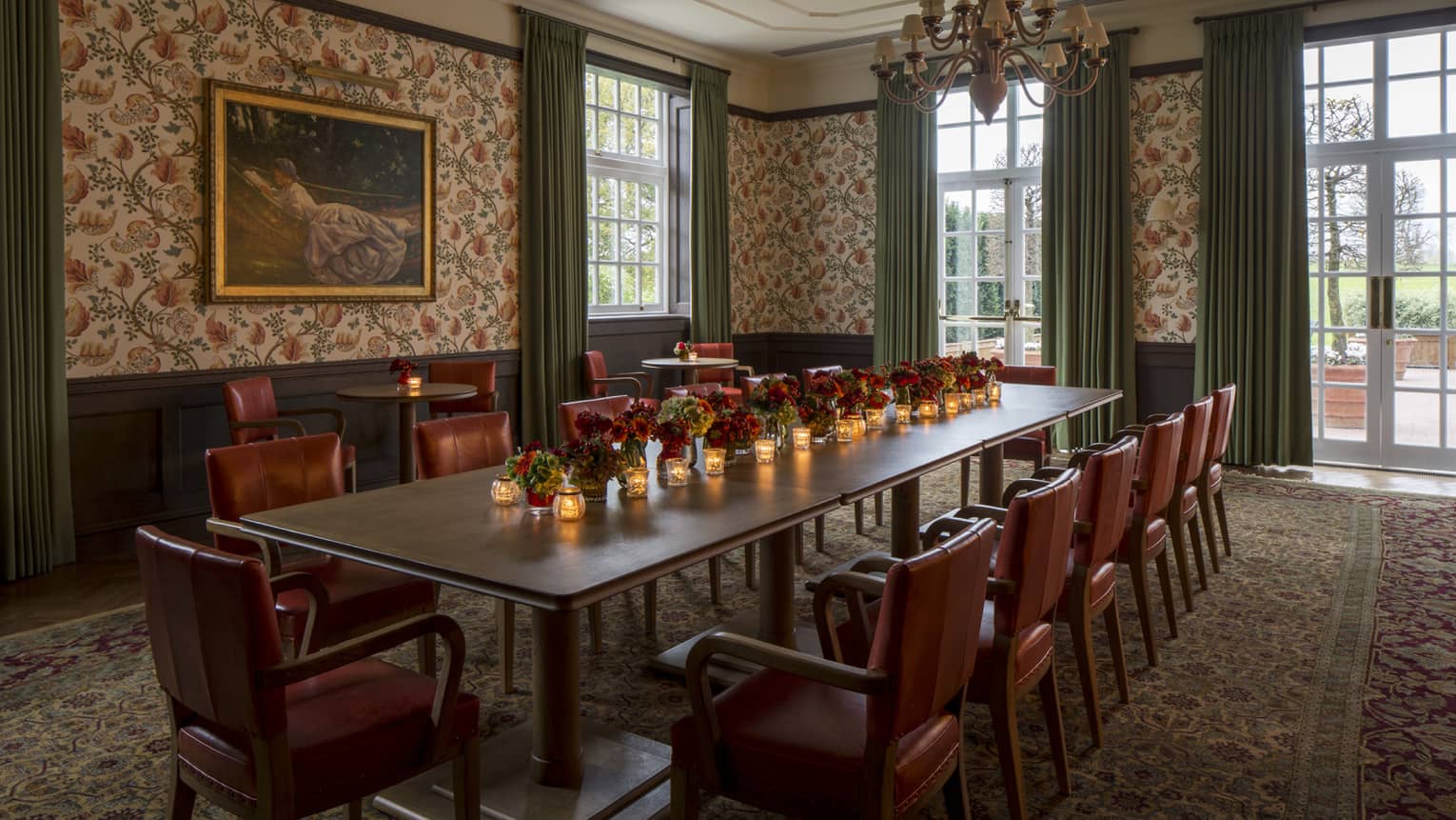 Fox Hollow private dining room, table with candles, red flowers and leather chairs