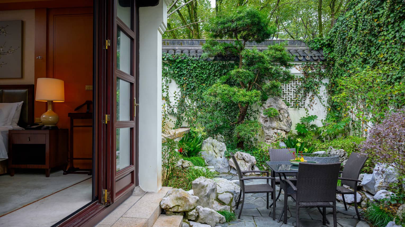 Private villa garden terrace with dining table for four at Four Seasons Hotel Hangzhou at West Lake