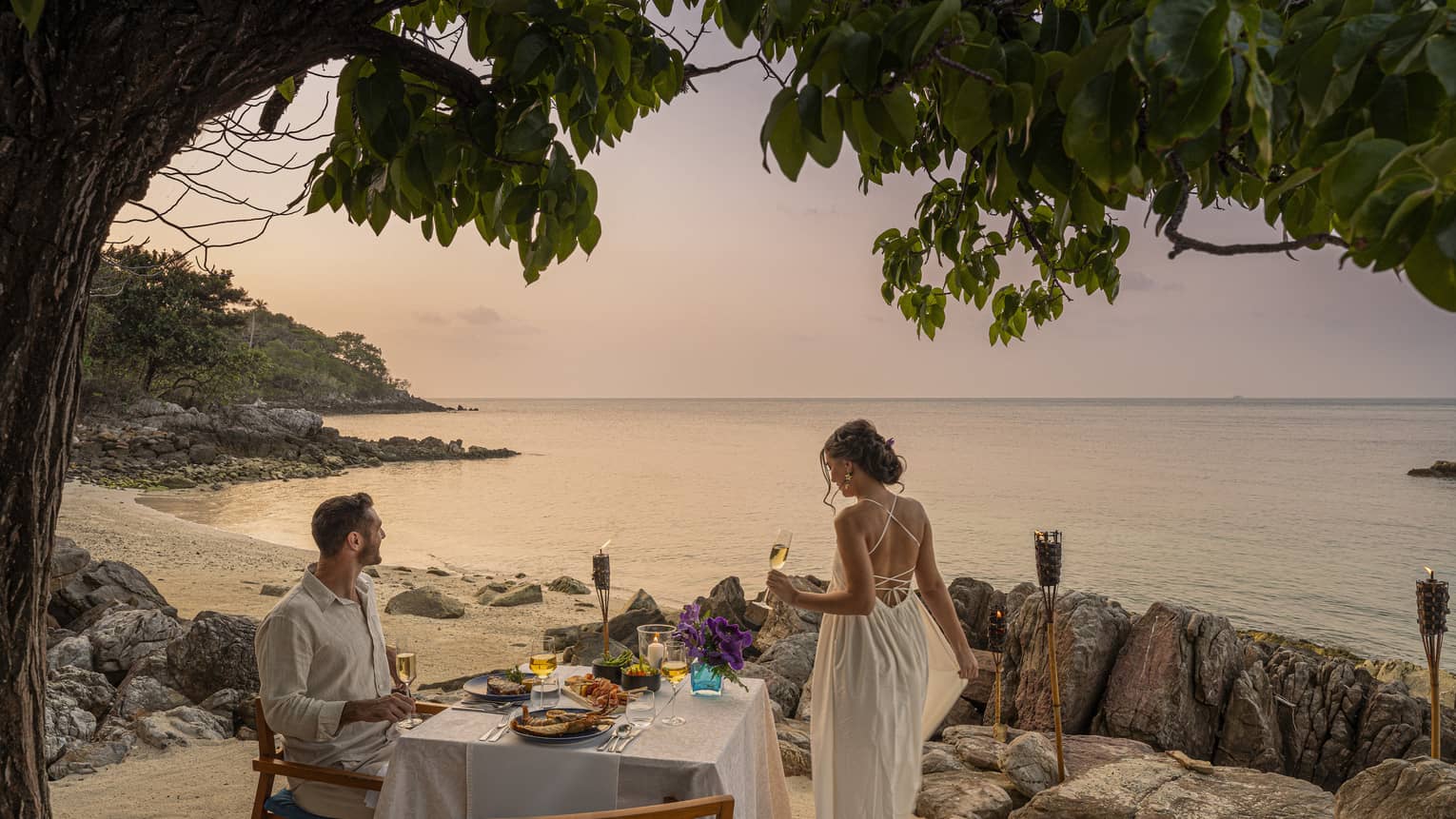 Couple enjoys oceanside sunset dinner