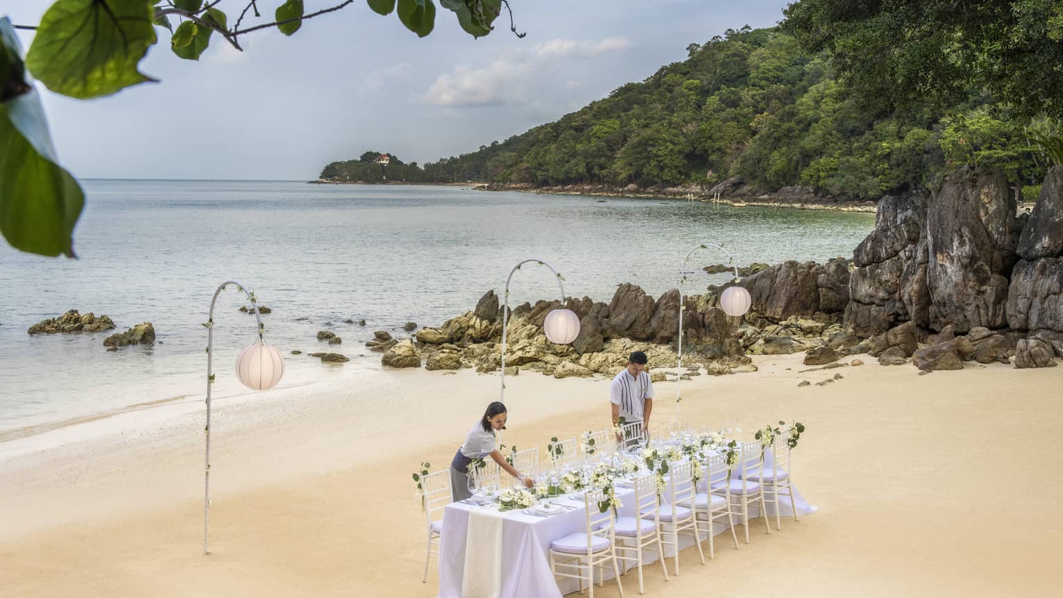 Team members set up a reception table on the beach