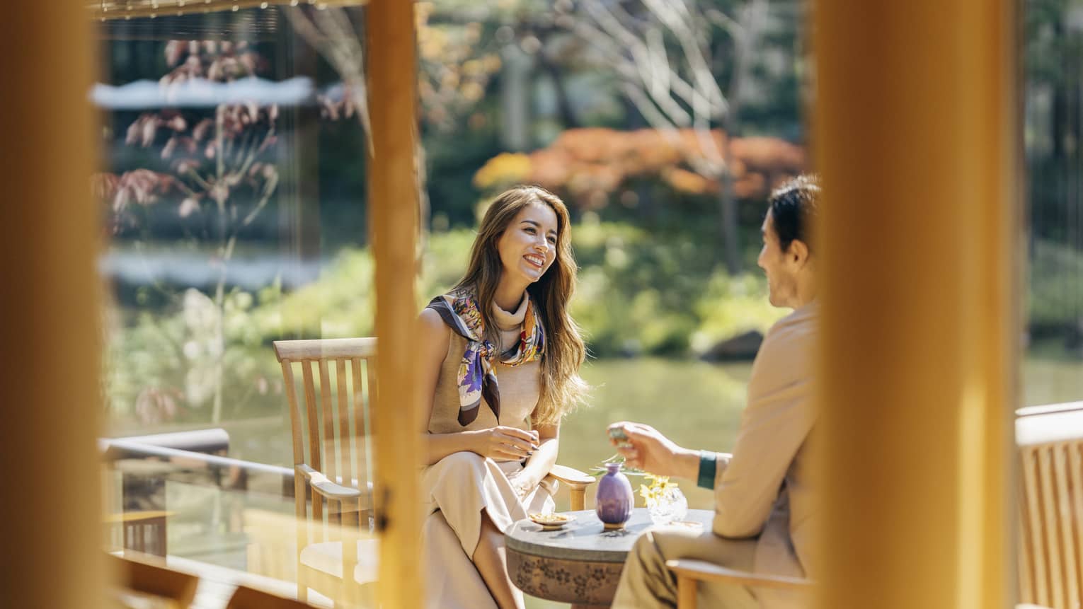 Smiling couple enjoys romantic dinner at Fuju's Shakusui-en pond garden