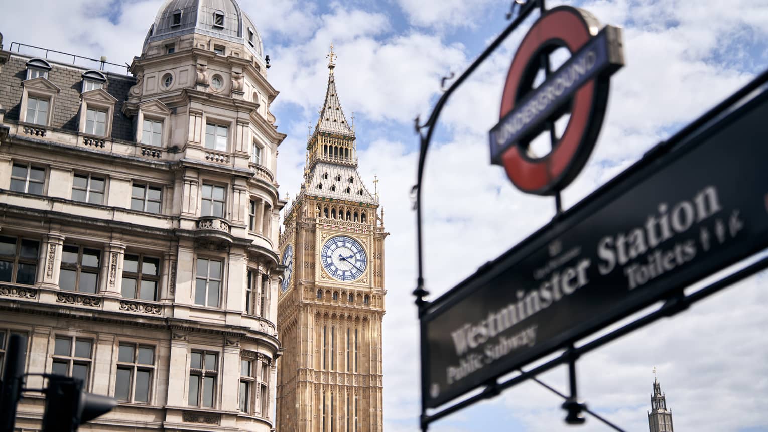 London Underground sign for Westminster Station in the foreground, Big Ben clock tower in the background.