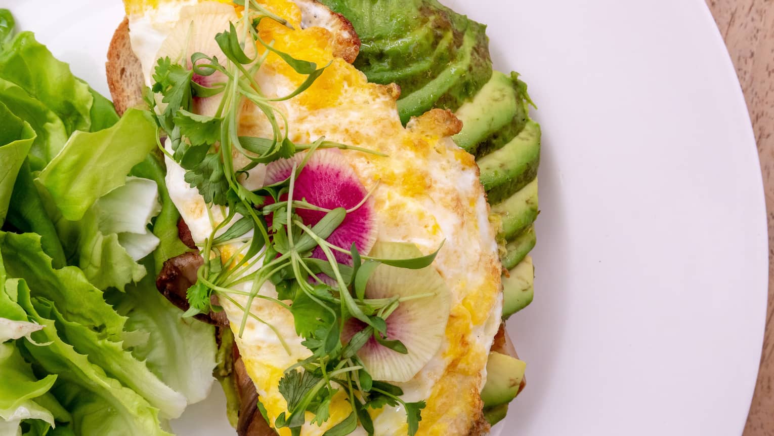 Avocado toast with egg and watercress on top