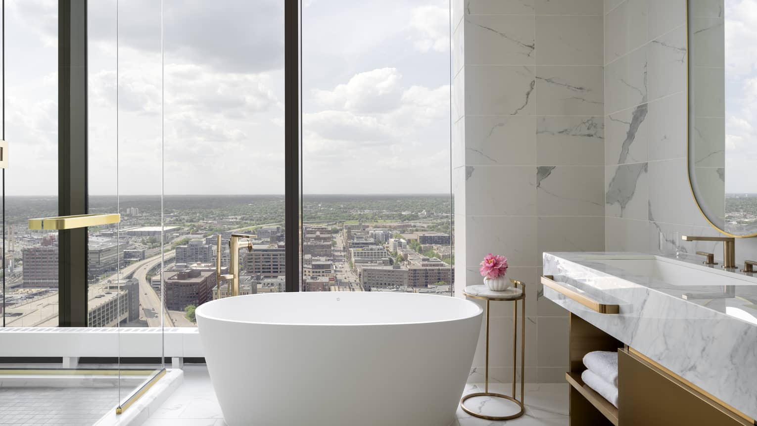 Bathroom with wall of windows and standalone tub