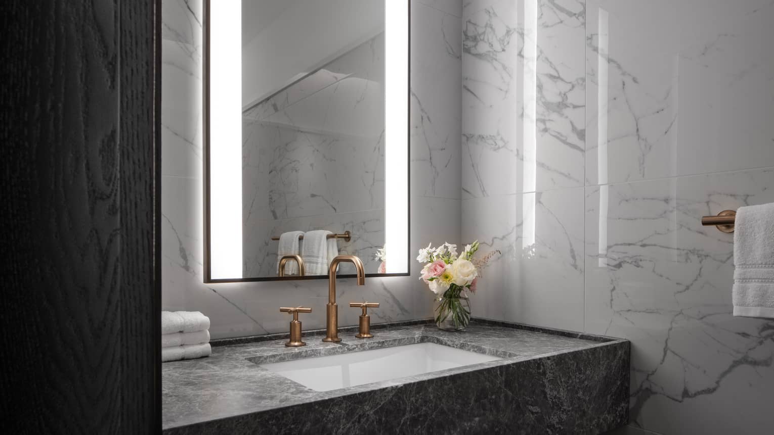 Marble bathroom vanity with illuminated mirror