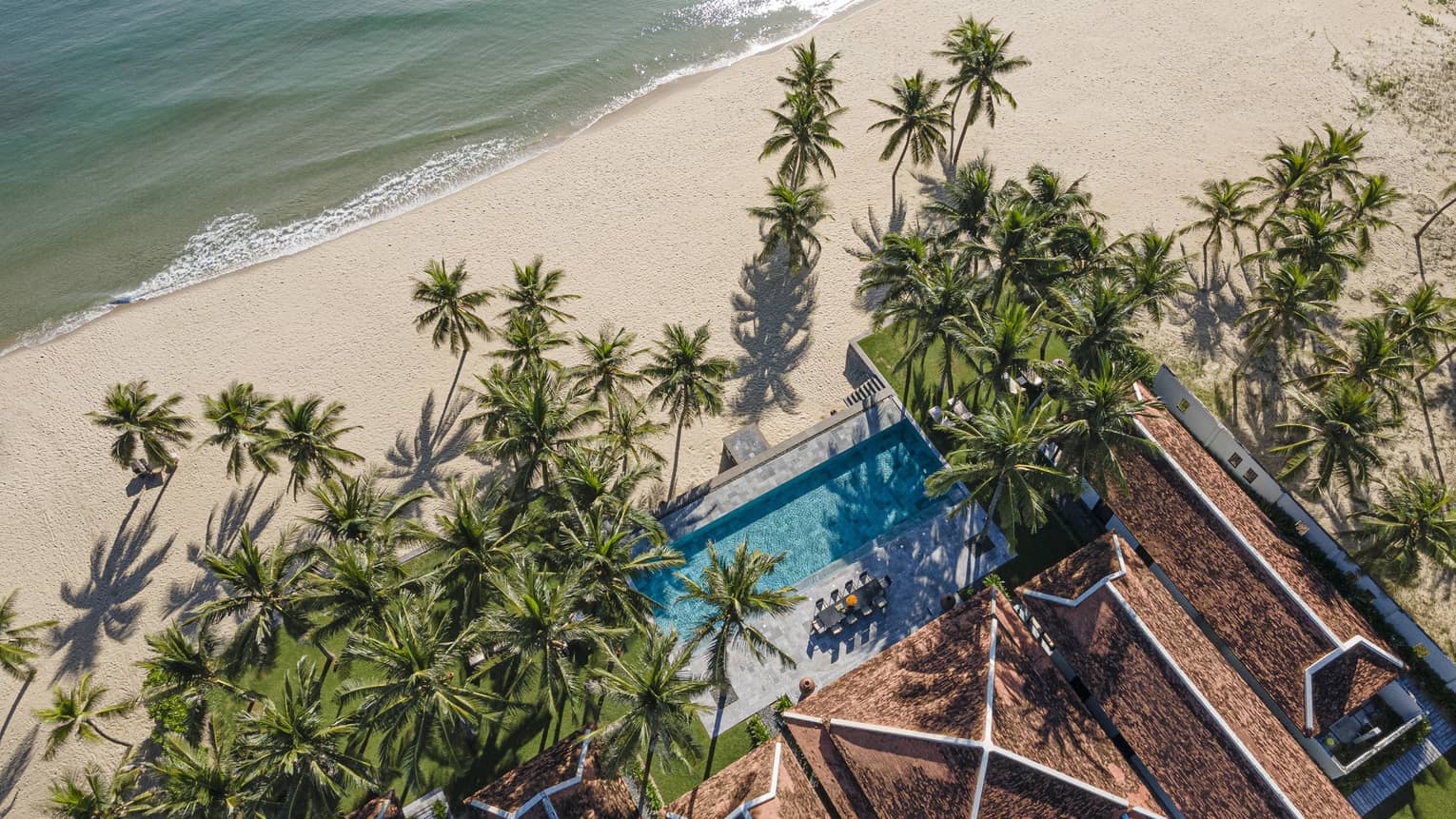 5 Bedroom Beachfront Pool Villa aerial shot with palm trees and ocean views