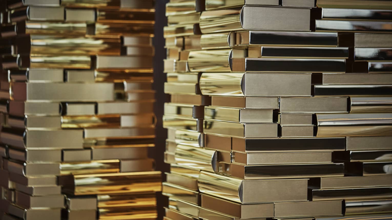Art installation resembling many golden stacked books