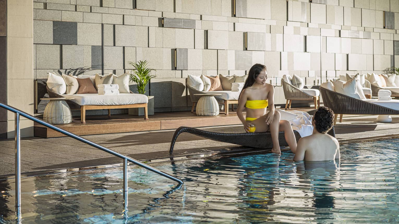 Couple relaxes poolside at the indoor pool