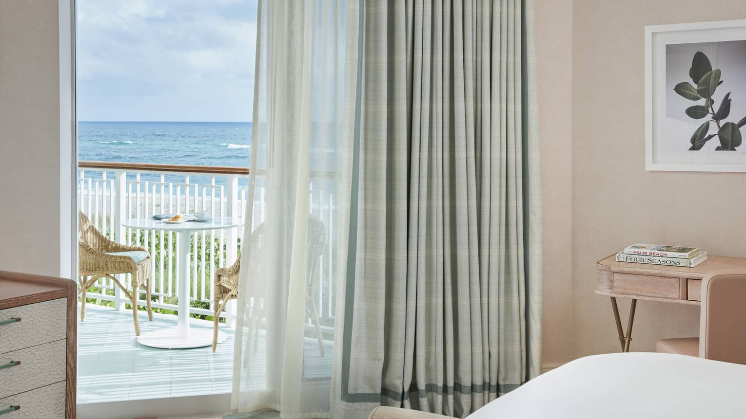 View of a guest room, looking out to private balcony with ocean views