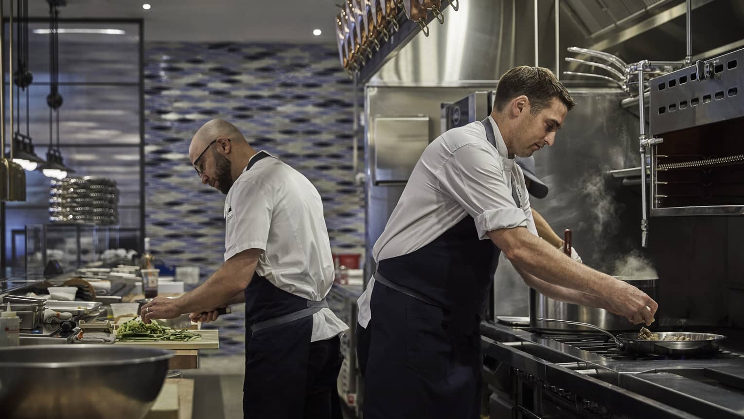 Chefs prepare meals in the kitchen of Four Seasons Philadelphia