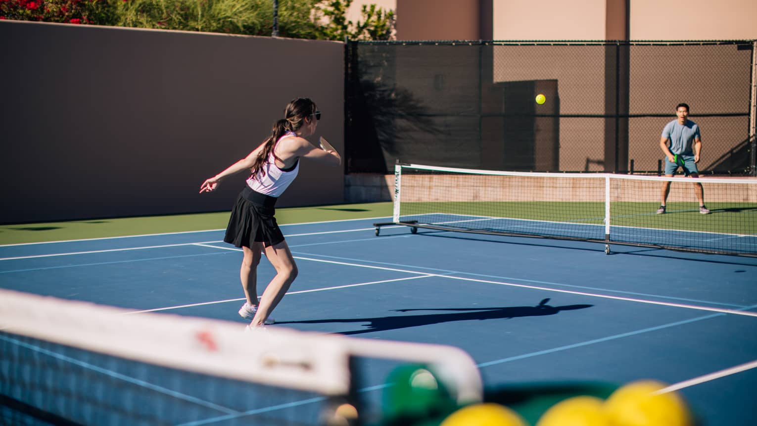 A woman and man on a tennis court.