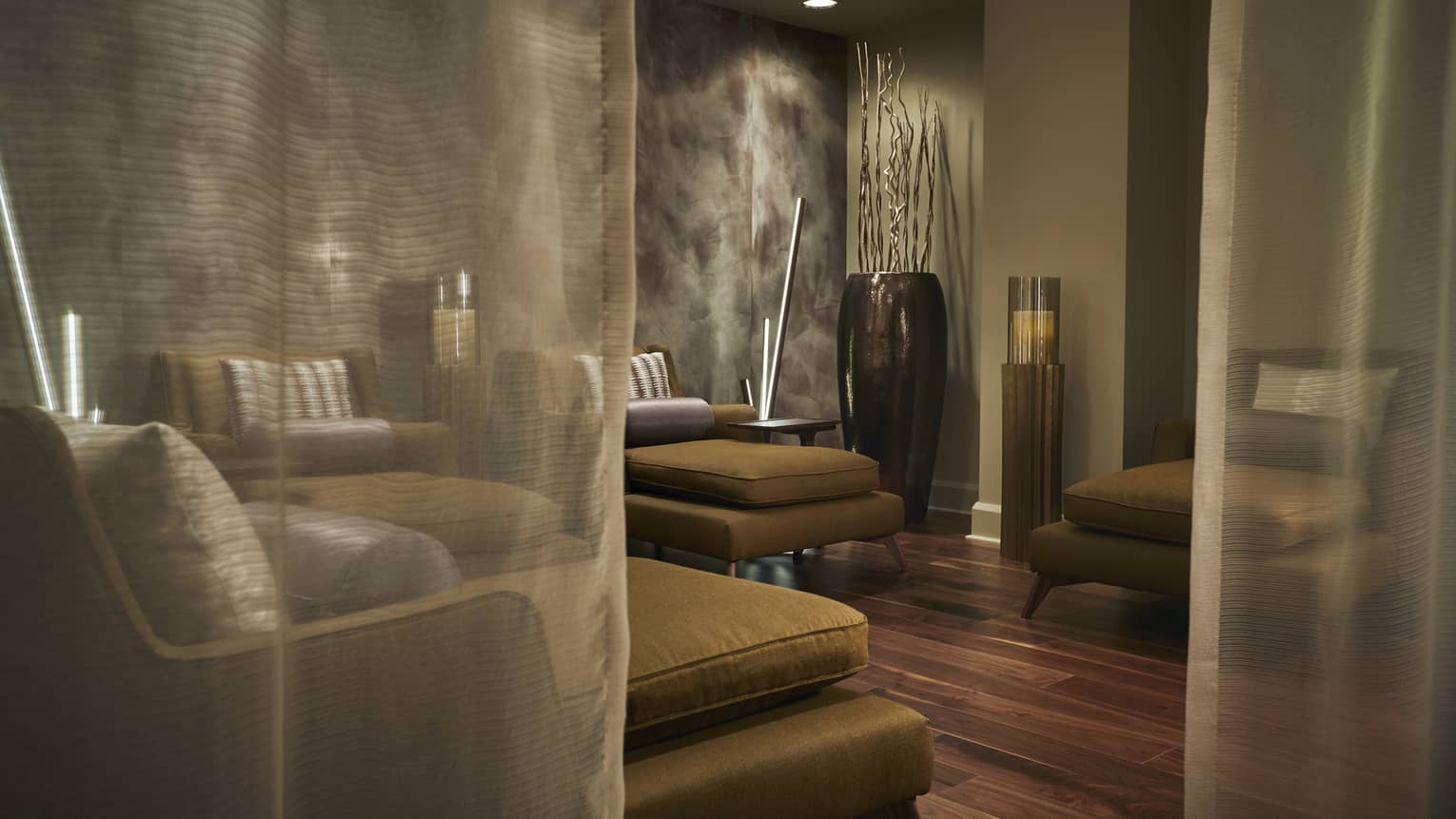 Sheer curtains by plush gold armchairs in Forbes Five Star Spa