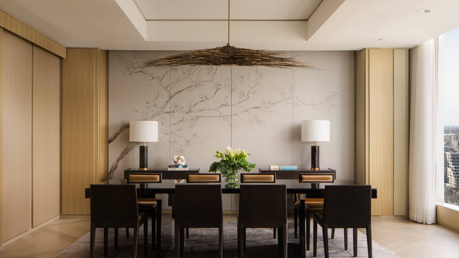 Dining table with eight seats and modern lighting fixture at Four Seasons Hotel Toronto